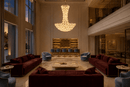 Modernus Grande large glass chandelier installed in a private club Miami with burgundy and bly sofas, marble floor and bar.