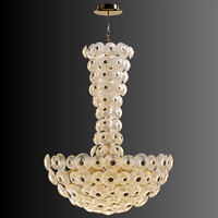 Modernus Grande chandelier rendered on black background showcasing cascading sculpted glass discs and brass-gold structure.