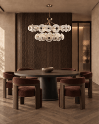 Modernus Halo art glass and copper chandelier by HDLS Lighting above a round table in a warm contemporary dining room.