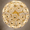 Close-up of illuminated Modernus Moon chandelier with textured Murano-style glass discs and gold frame.