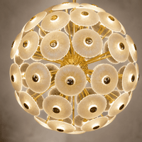 Close-up of illuminated Modernus Moon chandelier with textured Murano-style glass discs and gold frame.