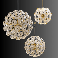 Set of Modernus Moon chandeliers featuring sculpted Murano-style glass discs arranged in glowing spherical forms.