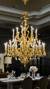 Palais Royal Grand Rococo Chandelier installed in a luxury dining room with 24K gold-plated copper and natural crystal.