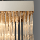 Close-up of Petra Argent rectangular chandelier with vertical glass rods, polished metal frame, and warm ambient glow