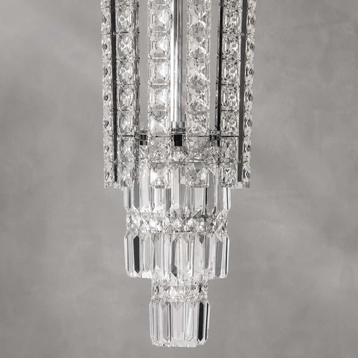 Close-up of Plaza Crown Column Crystal Chandelier with polished chrome and precision-cut crystal details