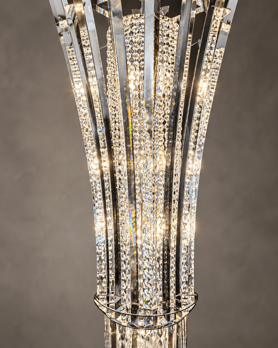 Close-up of Plaza Crown Prism chandelier showing tiered crystal pendants, chrome support rings and faceted crystal blades.