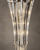 Close-up of Plaza Crown Prism chandelier showing tiered crystal pendants, chrome support rings and faceted crystal blades.