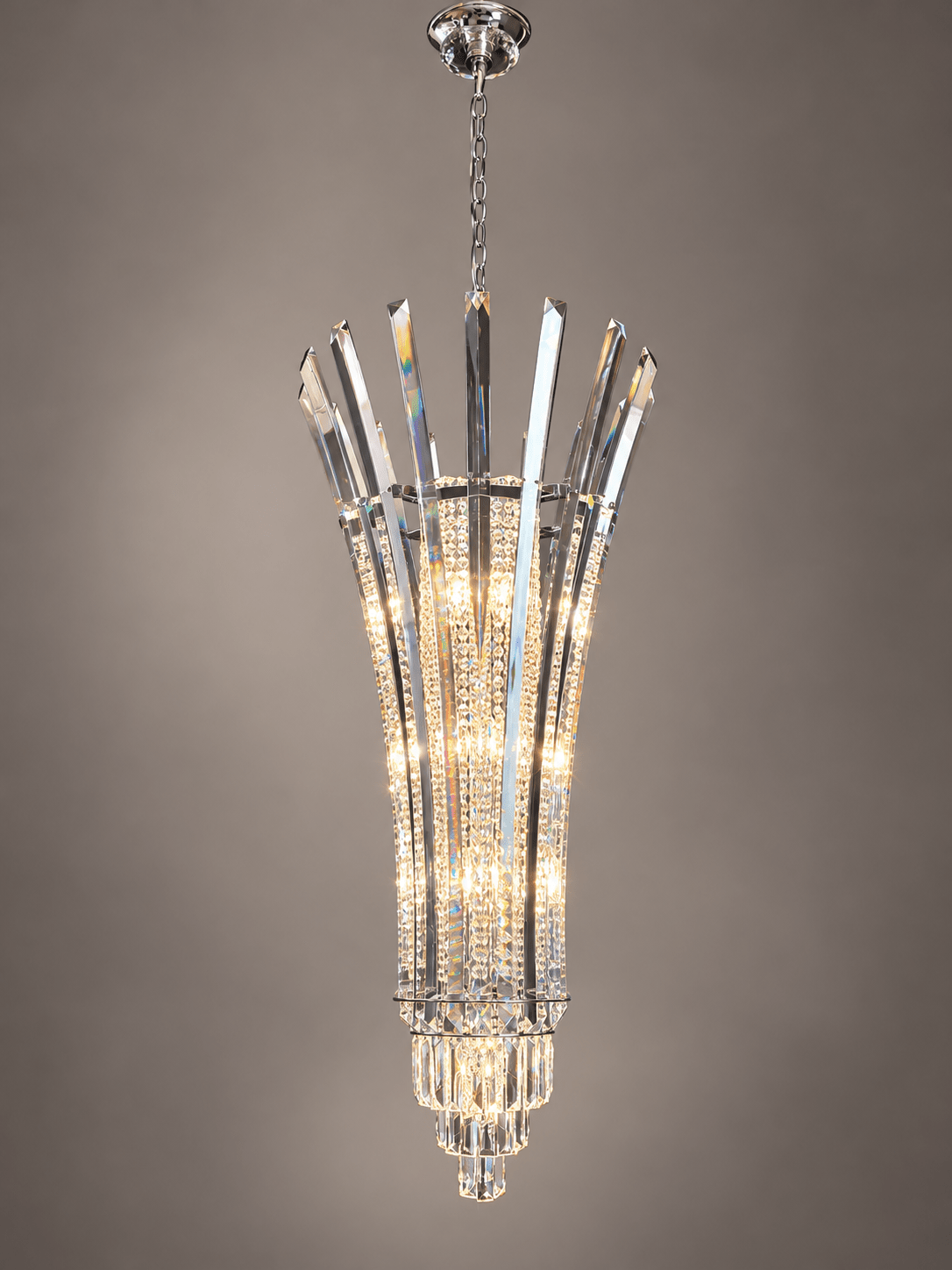 Plaza Crown Prism luxury staircase crystal chandelier featuring elongated solid crystal prisms and polished chrome details.