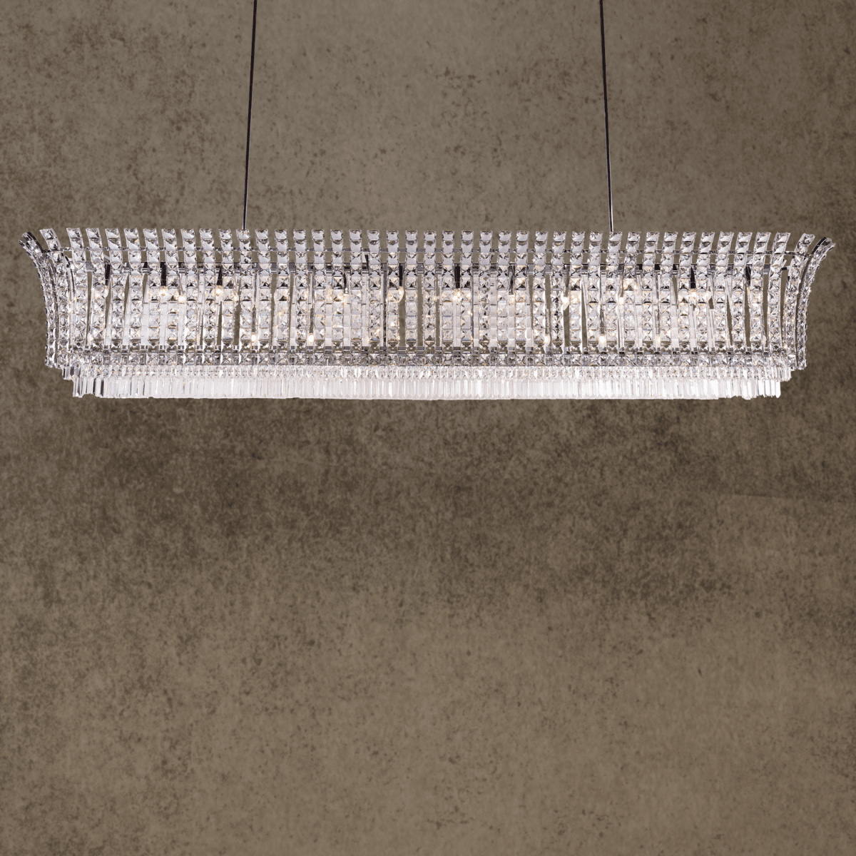 Linear crystal chandelier above dining table in luxury interior