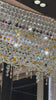 Close-up video of illuminated Asfour crystal and amber accents on the Aurelio Wave Oval chandelier.