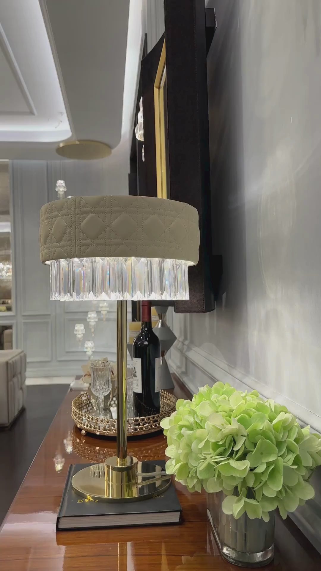 Short video of Florence Trapunto Thalia table lamp showcasing ivory quilted leather shade, crystal fringe, and warm LED illumination.