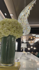 Aurelio Wave chandelier above a luxury bar counter in the HDLS showroom, highlighting sculptural crystal lighting