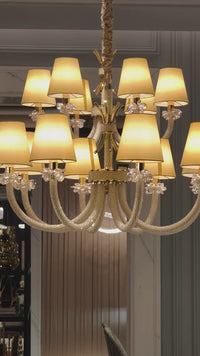 Video of the Maria Grandeur 15-light chandelier with ivory shades and crystal-wrapped arms showcased on a modern interior.