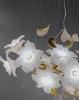 Video preview of Magnolia Grazia chandelier showing floating magnolia blooms and gold accents.