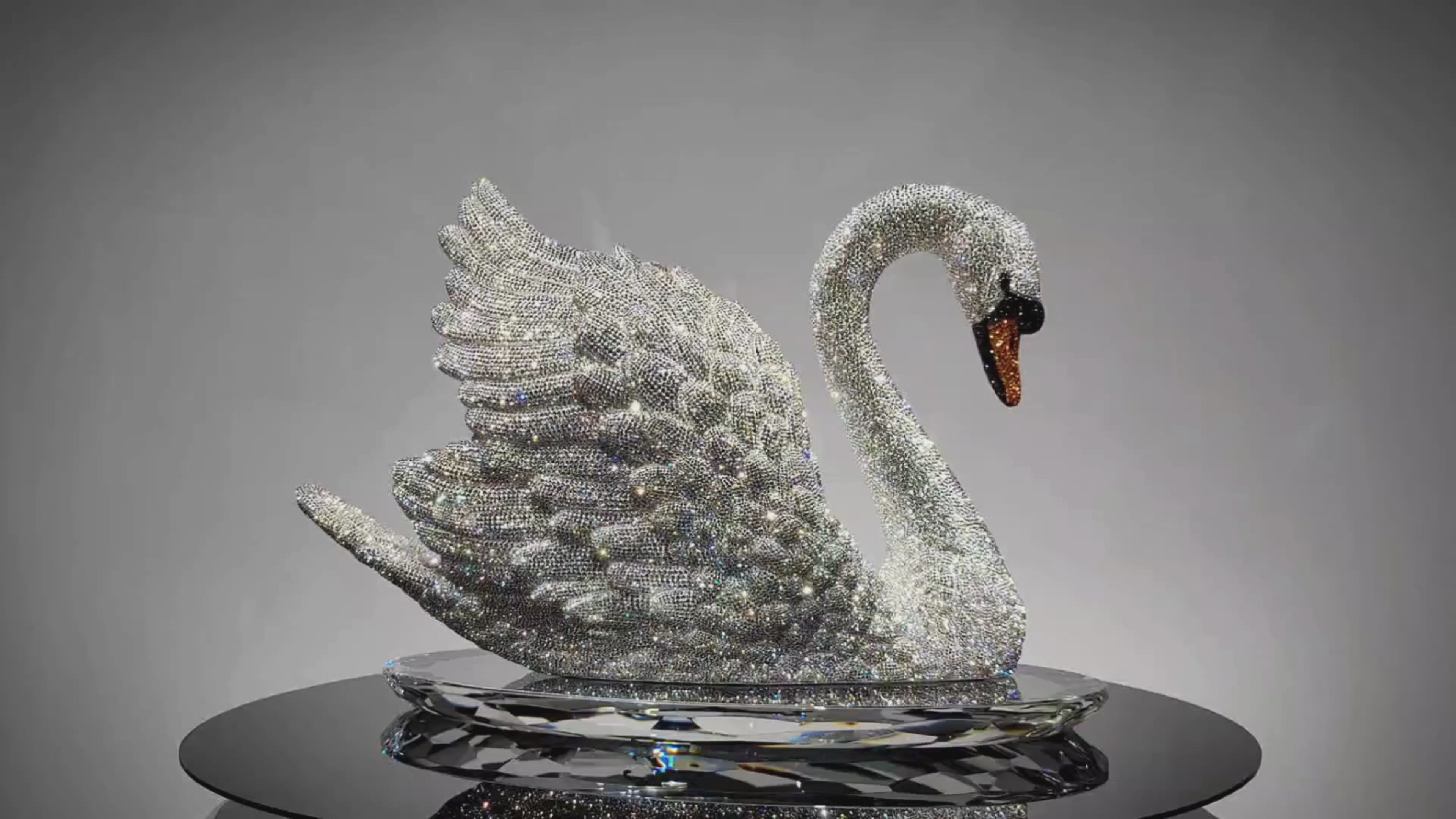 Video showing rotating VAGHAAR Swarovski crystal swan sculpture on crystal tray base.