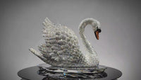 Video showing rotating VAGHAAR Swarovski crystal swan sculpture on crystal tray base.