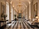 Regency Sovereign crystal chandeliers in a grand gallery with vaulted ceilings and black-and-white marble floor