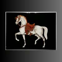 Luxury equestrian wall art with Swarovski crystals and red saddle displayed in silver frame on black background