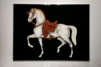 Close-up of Swarovski embellished horse head and red saddle, showcasing handcrafted mixed-media luxury detailing