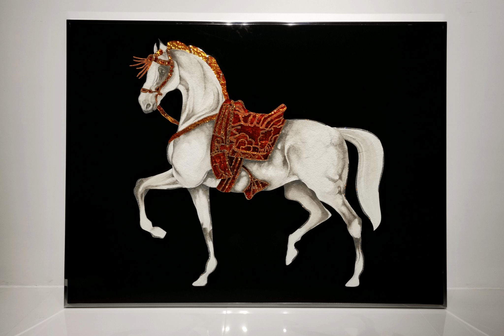 Close-up of Swarovski embellished horse head and red saddle, showcasing handcrafted mixed-media luxury detailing