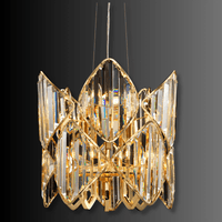 Sculptural luxury crystal pendant chandelier with gold-plated copper frame and layered faceted crystals.