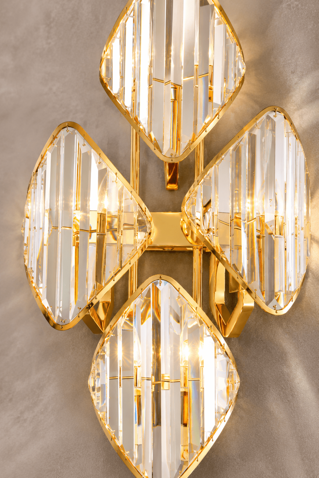 Solaris Ignis crystal wall sconce close-up with faceted crystal prisms and polished gold frame