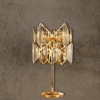 Solaris Lyra luxury crystal table lamp in 18K gold-plated copper with precision-cut prisms, front view.