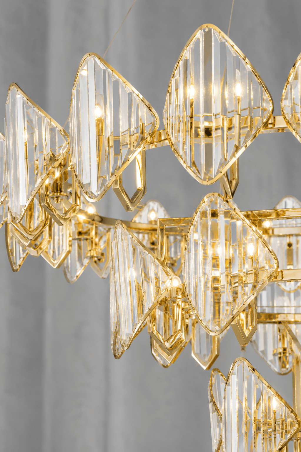 Close-up of Solaris Mitra luxury crystal chandelier with 18K gold frame and precision-cut crystal panels