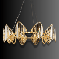 Angled view of Solaris Orion luxury crystal chandelier with geometric prisms and gold-plated frame