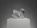 Luxury Swarovski crystal swan sculpture VAGHAAR shown in elegant angled profile on gallery pedestal.