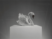 Luxury Swarovski crystal swan sculpture VAGHAAR shown in elegant angled profile on gallery pedestal.