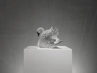 Rear view of VAGHAAR crystal swan sculpture highlighting layered wing detailing and crystal brilliance.
