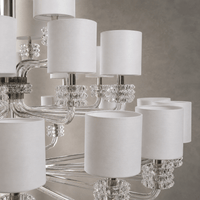 Close-up of Varella Grand Crystal Chandelier with polished nickel arms, crystal accents and white fabric shades