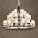 Varella Chandelier with 36 light bulbs and crystal arms on a brown background.