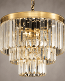 Close-up of Vendôme Bijou crystal chandelier with faceted prisms and warm 18K gold-plated frame.