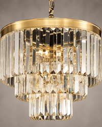 Close-up of Vendôme Bijou crystal chandelier with faceted prisms and warm 18K gold-plated frame.