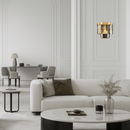 Vendôme Boutique 18K gold crystal wall sconce in a minimalist living room, offering warm luxury lighting for modern spaces.