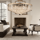 Vendôme Grandeur chandelier illuminating luxury living room with warm golden crystal brilliance.