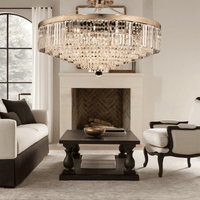 Vendôme Grandeur chandelier illuminating luxury living room with warm golden crystal brilliance.