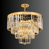 Angled view of the Vendôme Lumière 18K gold crystal chandelier, French-inspired luxury lighting for compact interior spaces.