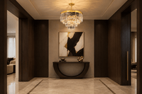 Vendôme Lumière crystal chandelier illuminating a luxury entrance hall with dark wood and stone flooring.