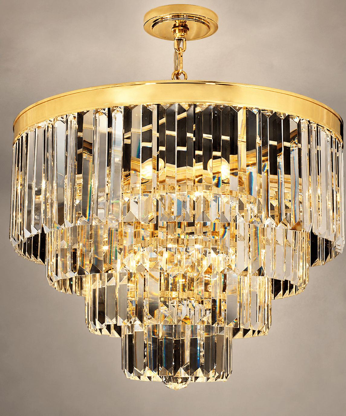 Close-up of Vendôme Lumière crystal chandelier with tiered clear crystals and a polished gold frame.
