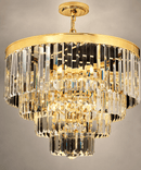 Close-up of Vendôme Lumière crystal chandelier with tiered clear crystals and a polished gold frame.