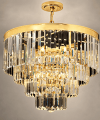 Close-up of Vendôme Lumière crystal chandelier with tiered clear crystals and a polished gold frame.
