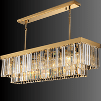 Angled view of the Vendôme Prestige chandelier showing 18K gold frame and Asfour crystals for elegant kitchen island and dining space lighting.