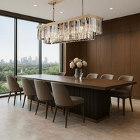 Vendôme Prestige linear crystal chandelier in an elegant dining room, providing warm illumination and refined 18K gold luxury design presence.