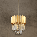 Luxury crystal pendant in 24K gold-plated stainless steel shown against textured wall