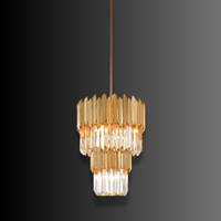 Statement crystal kitchen island pendant lighting in luxury gold finish with tiered crystal design.