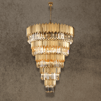 Grand five-tier crystal chandelier in gold finish with cascading tiers for double-height foyer lighting