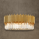 Zarrin Halo 24K gold-plated ring chandelier with crystal prisms, shown on textured architectural backdrop.
